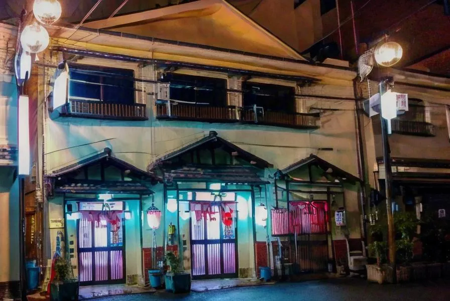 This AI-generated image created using Stable Diffusion depicts a Japanese street at night with an illuminated traditional building. The building features typical Japanese architecture and is adorned with soft lights and red lanterns, creating a warm ambiance.